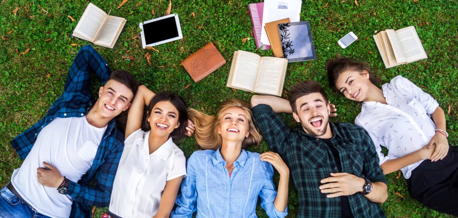 Students life. Low angle view of cheerful young people communica